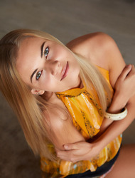 Leggy blonde beauty Nordica relaxes in her loft apartment, in skyscraper heels and a dress that barely skims her tanned thighs