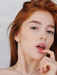 Porcelain pale beauty Jia Lissa lies on her bed in sexy blue lingerie